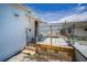 Back patio area featuring chain link fence and tiled surface with limited patio furniture at 124 Athens St, Tarpon Springs, FL 34689