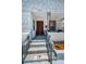 Inviting front porch with stylish decor, a dark red door, and classic brickwork at 124 Athens St, Tarpon Springs, FL 34689