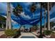 Charming town square shaded by blue canopies and surrounded by palm trees at 124 Athens St, Tarpon Springs, FL 34689