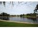 Beautiful water view showcasing lush greenery, a palm tree, and the architecture of nearby buildings at 124 Athens St, Tarpon Springs, FL 34689