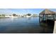 Waterfront view of boats, docks, and a tiki hut on a serene river at 124 Athens St, Tarpon Springs, FL 34689