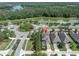 Scenic aerial view of a residential home near a peaceful lake and lush green spaces at 12420 Rangeland Blvd, Odessa, FL 33556