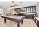 Basement showcasing the pool table, custom bar, and entertainment area with plenty of room for guests at 12420 Rangeland Blvd, Odessa, FL 33556