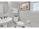 Bathroom featuring a pedestal sink, toilet, neutral walls, and a window with blinds at 12420 Rangeland Blvd, Odessa, FL 33556