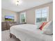 Bedroom featuring carpet, a dresser, a bed, and natural light from the two windows at 12420 Rangeland Blvd, Odessa, FL 33556
