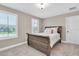Cozy bedroom with a wooden sleigh bed, carpeted floors, and two windows for natural light at 12420 Rangeland Blvd, Odessa, FL 33556