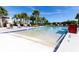 Zero entry community pool with lounge chairs and umbrellas, offering a resort-style experience at 12420 Rangeland Blvd, Odessa, FL 33556