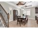 Dining room showcasing a dining table, chairs, a china cabinet, and staircase at 12420 Rangeland Blvd, Odessa, FL 33556