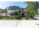 Charming two-story home with a well-manicured lawn, dark shutters, and a welcoming front porch at 12420 Rangeland Blvd, Odessa, FL 33556