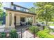 Inviting front porch with stone accents, a seating area, and a wrought iron fence at 12420 Rangeland Blvd, Odessa, FL 33556