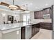 Open-concept kitchen with an island, stainless steel appliances, and views into the dining area at 12420 Rangeland Blvd, Odessa, FL 33556