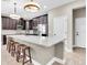 Spacious kitchen with a large island, modern appliances, dark cabinetry, and stylish pendant lighting at 12420 Rangeland Blvd, Odessa, FL 33556