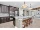 Modern kitchen with stainless steel appliances, granite countertops, and a large island with seating at 12420 Rangeland Blvd, Odessa, FL 33556