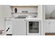 Bright laundry room with modern washer and dryer, storage cabinets and folding counter space at 12420 Rangeland Blvd, Odessa, FL 33556