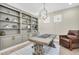 Inviting home office with custom built-ins, decorative lighting, and ample workspace at 12420 Rangeland Blvd, Odessa, FL 33556