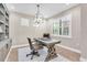 Stylish office with a decorative chandelier, plantation shutters, and wooden floors at 12420 Rangeland Blvd, Odessa, FL 33556