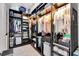 Well-organized walk-in closet with custom shelving and ample storage space for clothes and accessories at 12420 Rangeland Blvd, Odessa, FL 33556