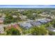 An aerial view showcases the neighborhood's lush landscaping and homes with pools at 1245 Overland Dr, Spring Hill, FL 34608