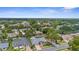 Aerial view of a suburban neighborhood showcasing well-maintained homes and lush greenery on a sunny day at 1245 Overland Dr, Spring Hill, FL 34608