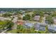 Aerial view of the homes featuring pools, mature trees, and manicured lawns in the neighborhood at 1245 Overland Dr, Spring Hill, FL 34608