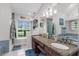 Dual sink bathroom showcasing an eye-catching granite countertop and plenty of natural light at 1245 Overland Dr, Spring Hill, FL 34608