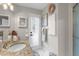 Bright bathroom with granite countertop vanity, decorative mirror and neutral accents at 1245 Overland Dr, Spring Hill, FL 34608