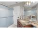 Bathroom with granite countertop vanity, decorative mirror and glass enclosed shower at 1245 Overland Dr, Spring Hill, FL 34608