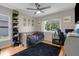 Bright bedroom features a ceiling fan, large window, and a shoe display at 1245 Overland Dr, Spring Hill, FL 34608