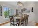 Traditional dining room featuring wood table set, a modern chandelier, and a picturesque window view at 1245 Overland Dr, Spring Hill, FL 34608