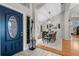 Open foyer with a stylish blue front door leading to a dining area with modern decor at 1245 Overland Dr, Spring Hill, FL 34608