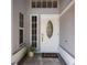 Inviting front entry with a white door, decorative glass, and a welcoming 'home' doormat at 1245 Overland Dr, Spring Hill, FL 34608