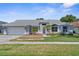 Charming single-story home featuring manicured landscaping, a two-car garage, and inviting curb appeal at 1245 Overland Dr, Spring Hill, FL 34608