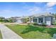Beautifully maintained single-story home with lush landscaping, a two-car garage, and a well-manicured lawn at 1245 Overland Dr, Spring Hill, FL 34608