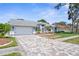 Lovely single-story home with a spacious driveway, a two-car garage, and beautifully landscaped front yard at 1245 Overland Dr, Spring Hill, FL 34608