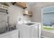 Well-lit laundry room features a new washer and dryer, and a utility sink at 1245 Overland Dr, Spring Hill, FL 34608