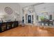 Open living area featuring hardwood floors, a dining area, and a view of the front entrance at 1245 Overland Dr, Spring Hill, FL 34608
