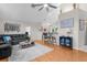Cozy living room featuring hardwood floors, a sectional couch, and views of the kitchen at 1245 Overland Dr, Spring Hill, FL 34608