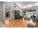 Bright living room with hardwood floors, a hutch, and sliding glass doors leading to an outdoor space at 1245 Overland Dr, Spring Hill, FL 34608