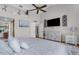 Relaxing bedroom with ceiling fan, en-suite bathroom, and view of a television and decor at 1245 Overland Dr, Spring Hill, FL 34608