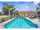 Inviting screened pool featuring clear water, dolphins, and lounge chairs at 1245 Overland Dr, Spring Hill, FL 34608