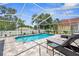 Sparkling screened-in pool with a sun lounger and landscaped surroundings at 1245 Overland Dr, Spring Hill, FL 34608