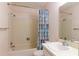 Cozy bathroom featuring a combination tub and shower, standard vanity with ample lighting, and updated fixtures at 12511 Dearborn Dr, Hudson, FL 34667