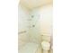 Renovated bathroom with modern tiles, sleek fixtures, glass shelves, and accessibility support for comfort at 12511 Dearborn Dr, Hudson, FL 34667