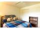 Bright bedroom featuring a ceiling fan, large window, closet, and a bookshelf; the room is ideal for relaxation at 12511 Dearborn Dr, Hudson, FL 34667