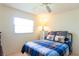 Relaxing bedroom with a window for natural light, a ceiling fan, and stylish decor at 12511 Dearborn Dr, Hudson, FL 34667