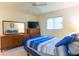 Bedroom featuring bed, dresser and a bright window at 12511 Dearborn Dr, Hudson, FL 34667