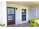 Entryway featuring a black framed door, window and neutral stucco siding at 12511 Dearborn Dr, Hudson, FL 34667