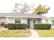 Inviting home featuring manicured hedges, a well-kept lawn, and a paved walkway to the front entrance at 12511 Dearborn Dr, Hudson, FL 34667
