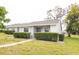 Attractive home with neatly trimmed hedges, a green lawn, and a pathway leading to the entrance at 12511 Dearborn Dr, Hudson, FL 34667