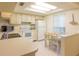 Bright kitchen with white appliances, tiled floors, a breakfast bar and a dining table at 12511 Dearborn Dr, Hudson, FL 34667